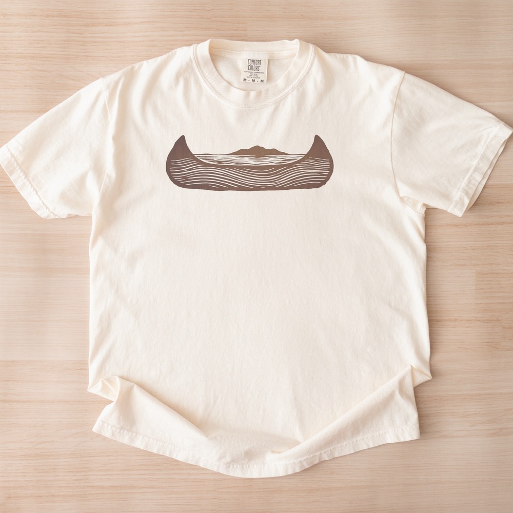 Canoe Carrying Mountains and Lake Within Its Hull Tee